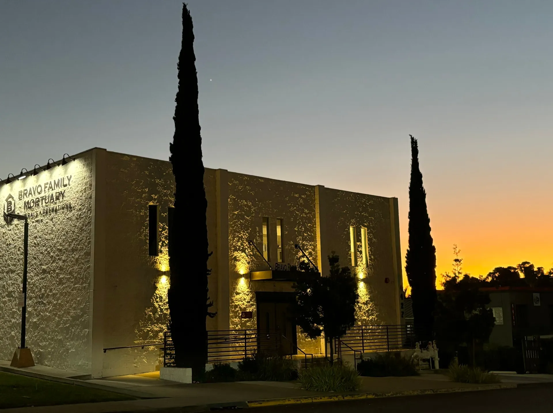 Bravo Family Mortuary building illuminated at sunset