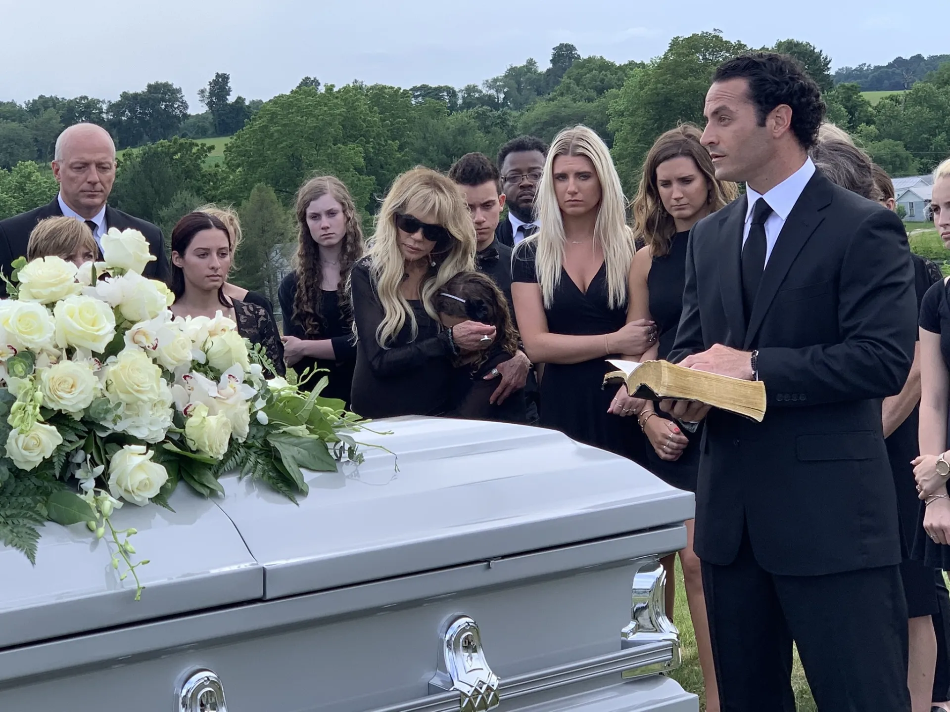 Graveside funeral service with flowers at a San Diego cemetery